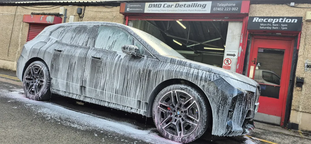 Snow foam pre-wash being applied to BMW iX M70 matte paintwork