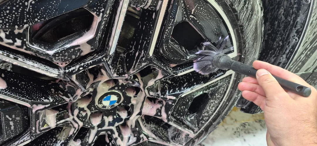BMW iX M70 wheel face being cleaned