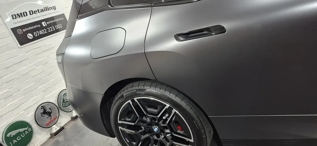 Rear quarter of BMW iX M70 Frozen Deep Grey paintwork