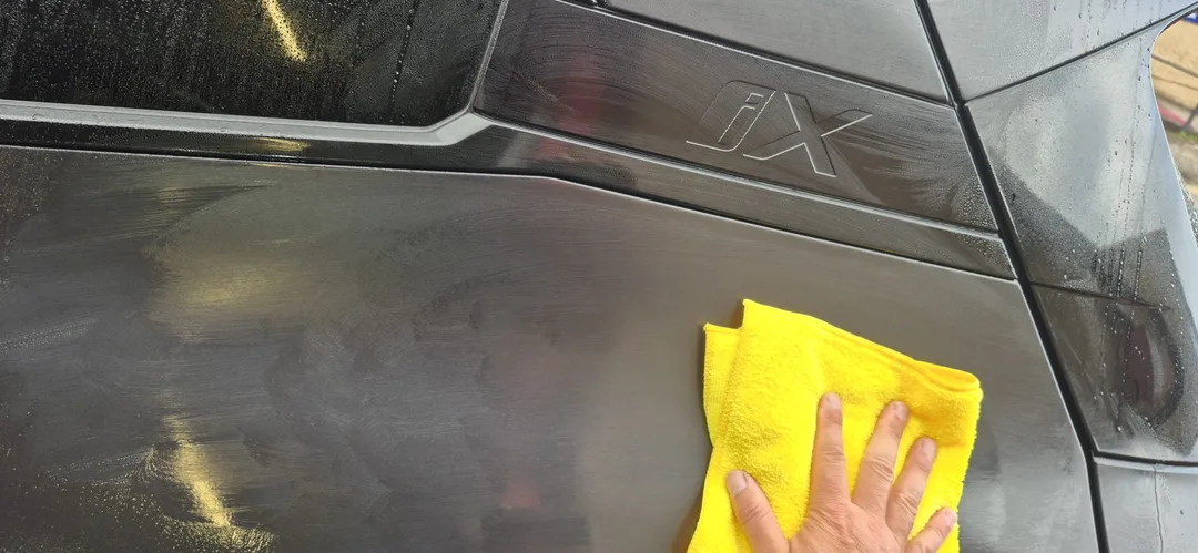 Tar and glue remover being used as part of the decontamination stage on this BMW iX M70